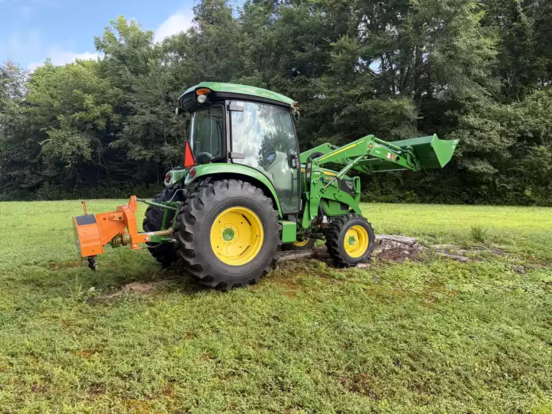 Tractor with bush hog mower clearing brush